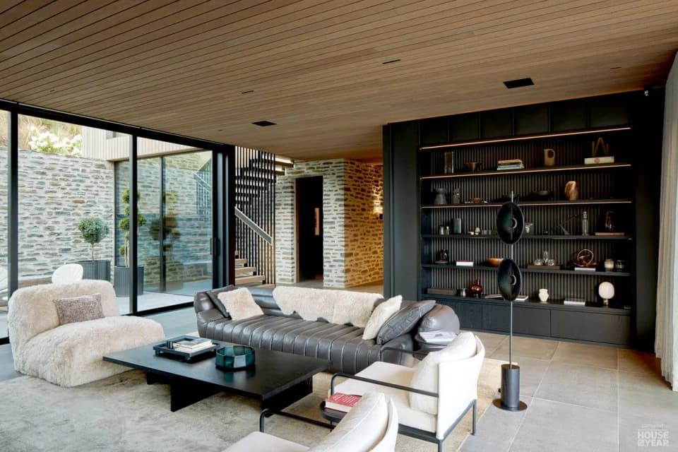 Black steel shelving wall running the length of a living room, Tucker Beach