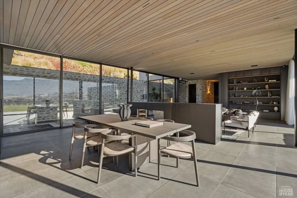 Covered outdoor dining area with a black steel shelving wall, Tucker Beach