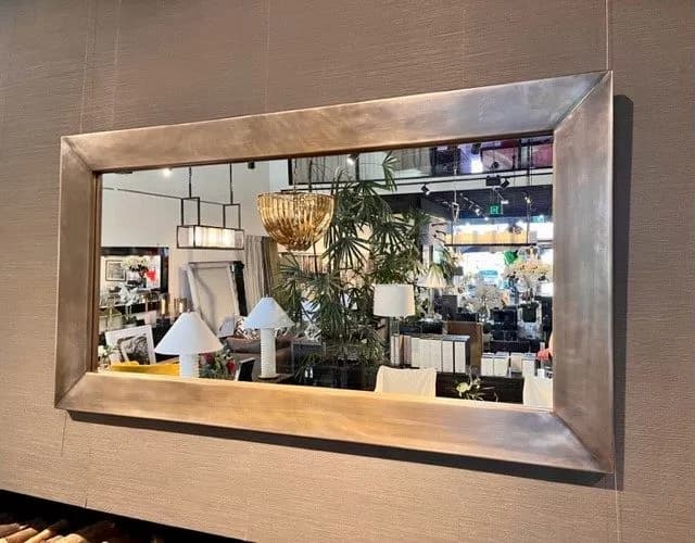 Large wall mirror with a wide brushed brass frame